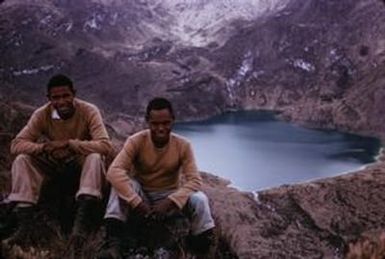 [Men sitting on a rock next to Lake Wanum, in Papua New Guinea ] BRIT-A-AR003-003-04-079