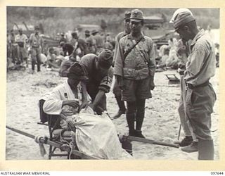 FAURO ISLAND, BOUGAINVILLE AREA. 1945-10-01. LIEUTENANT GENERAL H. HYAKUTAKE, COMMANDER 17 JAPANESE ARMY, SEATED IN A CARRYING CHAIR, TALKING TO JAPANESE TROOPS ON ARRIVAL AT FAURO ISLAND. ALL ..