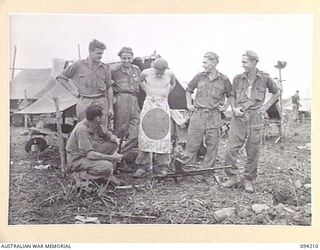 MOLONEY'S RIDGE, WEWAK, NEW GUINEA. 1945-07-13. MEMBERS OF TANK ATTACK PLATOON, A COMPANY, 2/5 INFANTRY BATTALION, WITH THEIR JAPANESE FLAG. THE FLAG WAS CAPTURED DURING A SIX HOUR ASSAULT AGAINST ..