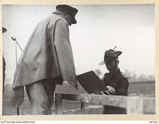 HERBERTON, QUEENSLAND. 1945-03-03. MAJOR GENERAL G.F. WOOTTEN, GENERAL OFFICER COMMANDING 9 DIVISION, (2), PRESENTING LIEUTENANT COLONEL N.W. SIMPSON, COMMANDING OFFICER, 2/43 INFANTRY BATTALION, ..