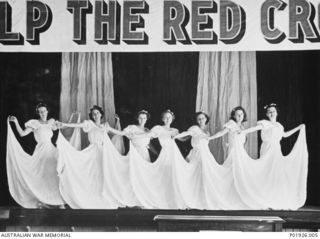Port Moresby, Papua. 1940-09-12. The chorus line of the amateur cast of a patriotic concert, providing entertainment in aid of the Red Cross, on stage. Members of the 'Sunny Side Up Company', they ..