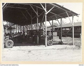 TOROKINA, BOUGAINVILLE. 1945-07-25. THE GUN PARK SHED AT 16 ADVANCED ORDNANCE DEPOT SHOWING 25-POUNDER GUNS UNDER STORAGE