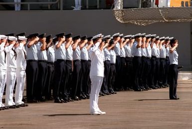 Navy, Coast Guard and Air Force personnel salute the Unknown Serviceman of the Vietnam Era as his casket is carried aboard the frigate USS BREWTON (FF 1086) for transport to California. The casket will be transferred to Arlington National Cemetery for interment at the Tomb of the Unknowns