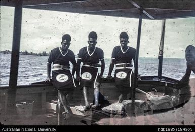 Three Papua New Guinean men in uniform with anchor logo