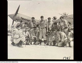 MOMOTE, LOS NEGROS ISLAND, ADMIRALTY ISLANDS. C. 1944-03. THE KITTYHAWK P40 AIRCRAFT ARE ON THE LINE AS SQUADRON LEADER LOUDON, THE COMMANDING OFFICER OF NO. 76 (KITTYHAWK) SQUADRON RAAF (CENTRE, ..