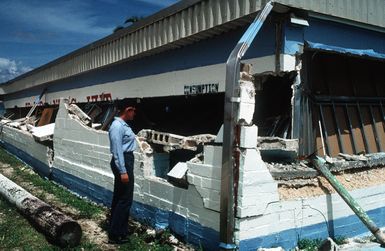 SEAMAN Kristine Garvey surveys damage sustained by Trader Andy's Hut, a pierside bar and grill, during an earthquake which struck the region on August 8th