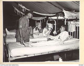 TOROKINA, BOUGAINVILLE, 1945-07-03. HIS ROYAL HIGHNESS, THE DUKE OF GLOUCESTER, GOVERNOR-GENERAL OF AUSTRALIA (3), SPEAKING TO PATIENTS DURING INSPECTION OF A WARD AT 2/1 GENERAL HOSPITAL. ..