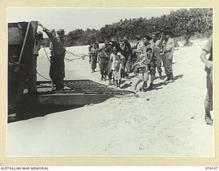 HANSA BAY, NEW GUINEA. 1944-06-16. CHINESE BEING TAKEN ABOARD AMERICAN ARMY BARGES FOR TRANSPORT TO MADANG. THESE PEOPLE WERE MEMBERS OF A PARTY OF SOME 90 CHINESE WHO WERE CAPTURED BY THE JAPANESE ..