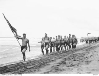 TOROKINA, BOUGAINVILLE, 1945-07-08. MEMBERS OF THE TEAM REPRESENTING THE ROYAL AUSTRALIAN AIR FORCE SURF LIVE SAVING CLUB, LED BY LEADING AIRCRAFTMAN NUBLEY, ONE OF THE CLUB'S EXAMINERS (1) TAKING ..
