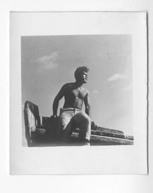 [Man Sitting on Edge of Boat]