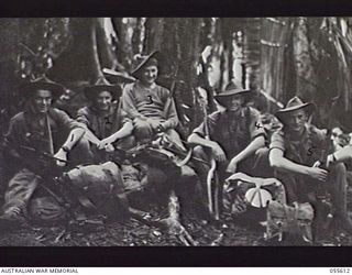 GOODVIEW, NEW GUINEA. 1943-08-11. TROOPS OF "C" COMPANY, 2/7TH BATTALION RESTING WHILE EN ROUTE TO THEIR NEW POSITIONS. LEFT TO RIGHT:- VX36146 SIGNALLER (SIG) C. R. SCOTT; VX58758 CORPORAL J. T. ..