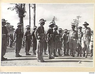 LAE AREA, NEW GUINEA, 1945-08-05. BRIGADIER P.S. MCGRATH, DEPUTY DIRECTOR OF SUPPLIES AND TRANSPORT (1), AND SENIOR OFFICERS INSPECTING 75 PLATOON, 151 GENERAL TRANSPORT COMPANY
