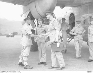 NADZAB AREA, NEW GUINEA, 1945-06-26. LT-GEN V.A.H. STURDEE, GOC FIRST ARMY (1) SHAKING HANDS WITH BRIG D.S. SCHREIBER (3) AIDE-DE-CAMP TO HIS ROYAL HIGHNESS, THE DUKE OF GLOUCESTER, GOVERNOR ..