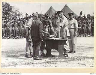 CAPE WOM, NEW GUINEA, 1945-09-13. LIEUTENANT-GENERAL ADACHI, COMMANDER 18 JAPANESE ARMY IN NEW GUINEA, DISCUSSING THE TERMS OF SURRENDER WITH MAJOR-GENERAL H.C.H. ROBERTSON, GENERAL OFFICER ..