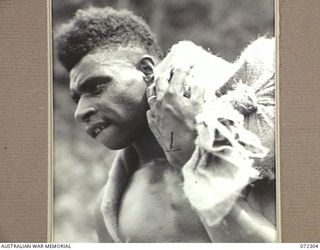 YAULA, NEW GUINEA. 1944-04-11. OBION, A MADANG BOY, CARRYING SUPPLIES DURING THE ADVANCE OF THE 57/60TH INFANTRY BATTALION TO BOGADJIM