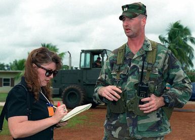 US Army Captain John Hackett, Commander, Company C, 1ST Battalion, 27th Infantry, 25th Infantry Division, answers questions from a local area reporter while working as a director of security at Andersen Air Force Base, Guam, during Operation PACIFIC HAVEN. The operation, a joint humanitarian effort conducted by the US military, entails the evacuation of over 2,100 Kurds (not shown) from northern Iraq to avoid retaliation from Iraq for working with the US government and international humanitarian agencies. The Kurds will be housed at Andersen AFB, while they go through the immigration process for residence in the United States