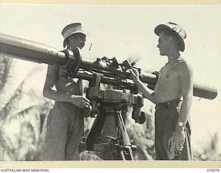 JACQUINOT BAY, NEW BRITAIN. 1944-11-17. VX126062 LANCE BOMBARDIER L.E. JUBB (1) AND VX86472 LANCE BOMBARDIER V. WILLIAMSON (2) OF THE 472ND HEAVY ANTI-AIRCRAFT BATTERY, CHECKING THE HEIGHT AND ..