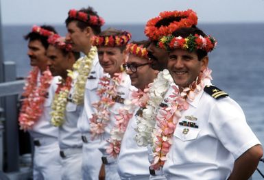 The officers of the salvage and rescue ship USS BRUNSWICK (ATS-3) wear garlands and leis presented to them after the ship's arrival at Majuro Atoll. The BRUNSWICK will be in the islands for 90 days while its crew salvages a wreck that is blocking the harbor at the island of Jaluit