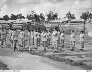 ENOGGERA, QUEENSLAND, 1945-04-26. THE CONTROLLER OF AUSTRALIAN WOMEN'S ARMY SERVICE, COLONEL S. H. IRVING, INSPECTING NO. 4 PLATOON OF 68 AUSTRALIAN WOMEN'S ARMY SERVICE BARRACK WHO WERE ON ..