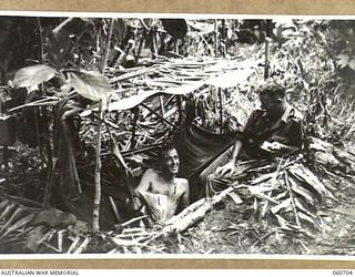 FINSCHHAFEN, NEW GUINEA. 1943-10-30. VX60731. PRIVATE J. T. HAMILTON OF ALBURY, VIC (LEFT), AND VX11799 PRIVATE F. R. DENNIS OF MILDURA, VIC, BOTH OF HEADQUARTERS, 26TH AUSTRALIAN INFANTRY BRIGADE ..