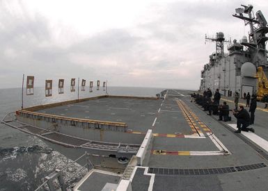 US Navy (USN) Sailors conduct live fire weapons qualification training using 5.56 mm M16A2 rifles, on the flight deck of the USN Tarawa Class Amphibious Assault Ship, USS SAIPAN (LHA 2), while the ship is underway in the Atlantic Ocean, conducting routine operations