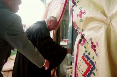 King Taufa'ahau Tupou IV, King of Tonga, entering church Vaine Mo'onia through a portal of fine mats