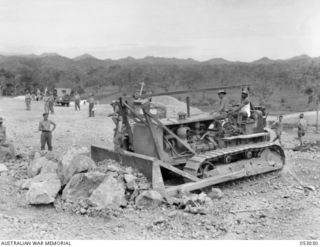 PORT MORESBY, NEW GUINEA. 1943-06-26. NINE MILE QUARRY WAS WORKED BY NATIVE LABOUR UNTIL 1942-02, WHEN IT WAS TAKEN OVER BY THE MILITARY FORCES. IT WAS THEN WORKED FOR PERIODS OF ABOUT SIX MONTHS ..