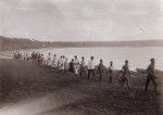 A procession walking along the bay of Wé, Lifou island
