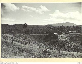 ILOLO, NEW GUINEA, 1944-03-30. THE MEN'S LINES AND THE ADMINISTRATIVE CENTRE AT THE NATIVE LABOUR CAMP, AUSTRALIAN NEW GUINEA ADMINISTRATIVE UNIT