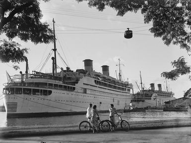 [The "Monterey" and "Mariposa" of the Matson Line, at dock in Tahiti. With bystanders]