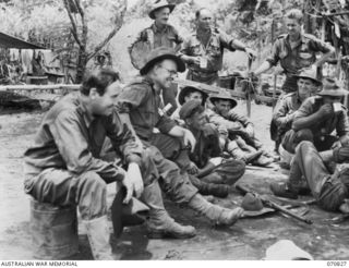 KESAWAI, RAMU VALLEY, NEW GUINEA, 1944-03-05. ALEX GURNEY, CREATOR OF THE "BLUEY AND CURLY" NEWSPAPER STRIP (1), AND MR. PURBERY (2), ACCREDITED WAR CORRESPONDENTS, TALK WITH TROOPS FROM 2/12TH ..