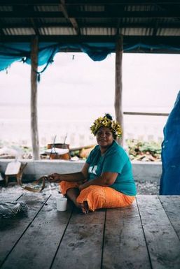 Sitting woman in fale, Fakaofo, Tokelau