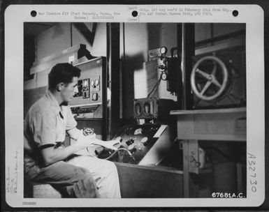 A "GI" tests the manifold pressure in the instrument shop of the 27th Air Depot Group at the Port Moresby Air Depot, Port Moresby, Papua, New Guinea. 1943. (U.S. Air Force Number 67681AC)