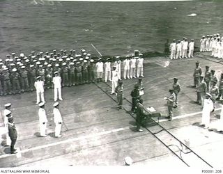 NEW BRITAIN, 1945-09-06. LIEUTENANT GENERAL SIR VERNON STURDEE READS THE SURRENDER CONDITIONS TO THE SENIOR OFFICERS OF THE JAPANESE SURRENDER PARTY ON BOARD HMS GLORY OFF RABAUL. (RNZAF OFFICIAL ..