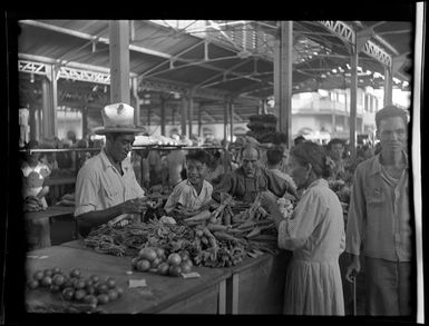 Market scene, elderly woman buying vegetables at stall, Papeete, Tahiti