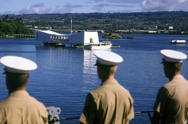 Members of the Marine detachment aboard the battleship USS MISSOURI (BB 63) stand at attention as the ship passes the USS ARIZONA Memorial. The ship is stopping in Hawaii prior to a cruise to Australia and around the world