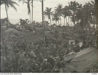 AITAPE AREA, NORTH EAST NEW GUINEA. 1944-04-22. AFTER A SUCCESSFUL LANDING MEMBERS OF A RAAF SURVEY AND DESIGN UNIT SAFELY ASHORE ARE MAKING THEIR WAY INLAND TO START CONSTRUCTIONAL WORK ON NEW ..