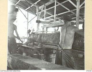 LAE, NEW GUINEA. 1944-09-27. LOGS BEING CUT INTO BOARDS AT A SAWMILL OF THE 43RD FIELD ORDNANCE DEPOT