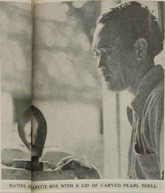 Native holding a cigarette box with a lid of carved pearl shell