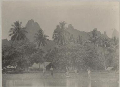 Fijians with a canoe in front of a Mission Station in Fiji, approximately 1895