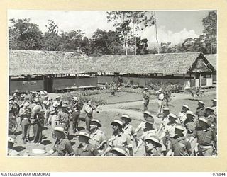 LAE, NEW GUINEA. 1944-11-11. THE COMMANDING OFFICER, VX104013 MAJOR I.A. WILSON, ACCOMPANIED BY THE ADJUTANT, NX112703 CAPTAIN O. HEWISON-COOPER, TAKING THE SALUTE FROM THE TROOPS OF THE 112TH ..