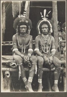 Mekeo [two men sitting side by side on a bamboo structure] Frank Hurley
