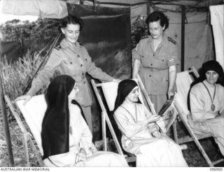 RABAUL AREA, NEW BRITAIN. 1945-09-17. SISTER M.M. WILSON (2) AND SISTER F.E. HENRY (4), ATTENDING SISTER MARY MICHAEL (1) AND SISTER MARY PHILOMENA (3), TWO OF THE NUNS EVACUATED FROM RAMALE ..