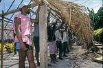 Young men lash thatch panels