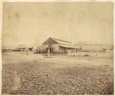 Foreshore of dock area showing damage to buildings after cyclone of 1878, Noumea, New Caledonia / Allan Hughan