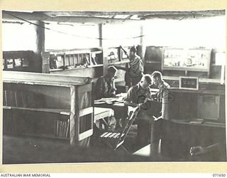 KOITAKI, PORT MORESBY AREA, PAPUA, NEW GUINEA. 1944-03-27. THE AUSTRALIAN ARMY EDUCATION SERVICE LIBRARY ATTACHED TO THE 113TH CONVALESCENT DEPOT VIEWED FROM THE REAR OF THE LIBRARY TOWARDS THE ..