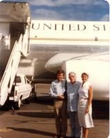 Claude Pepper posing with two others in front of a plane
