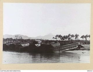 TOROKINA, BOUGAINVILLE, 1945-11-28. DERELICT BARGES ON THE BEACH OF TOROKINA HARBOUR