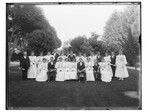 Young men and women with diplomas in park