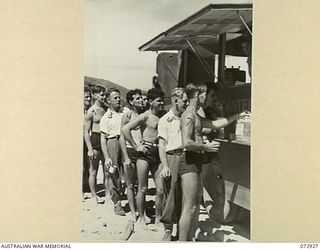 KILA BEACH, PORT MORESBY, NEW GUINEA. 1944-05-11. V2/363 MRS N. LYNCH (9), A MEMBER OF THE AUSTRALIAN RED CROSS ATTACHED TO THE 2/1ST GENERAL HOSPITAL, POURS TEA FROM A MOBILE CANTEEN WHICH OFFERS ..